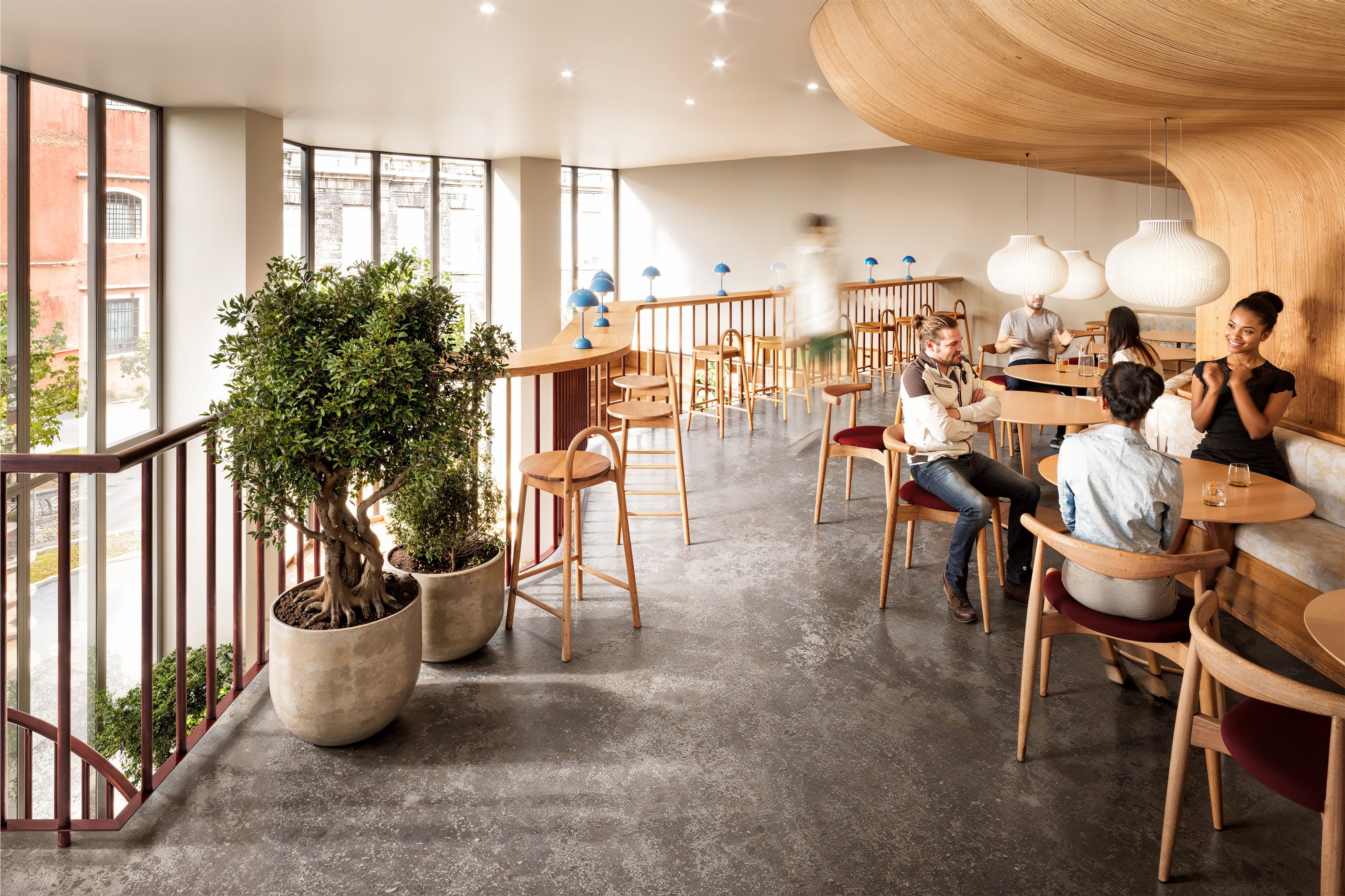 Counter restaurant interior with terracotta walls and an open kitchen pass.